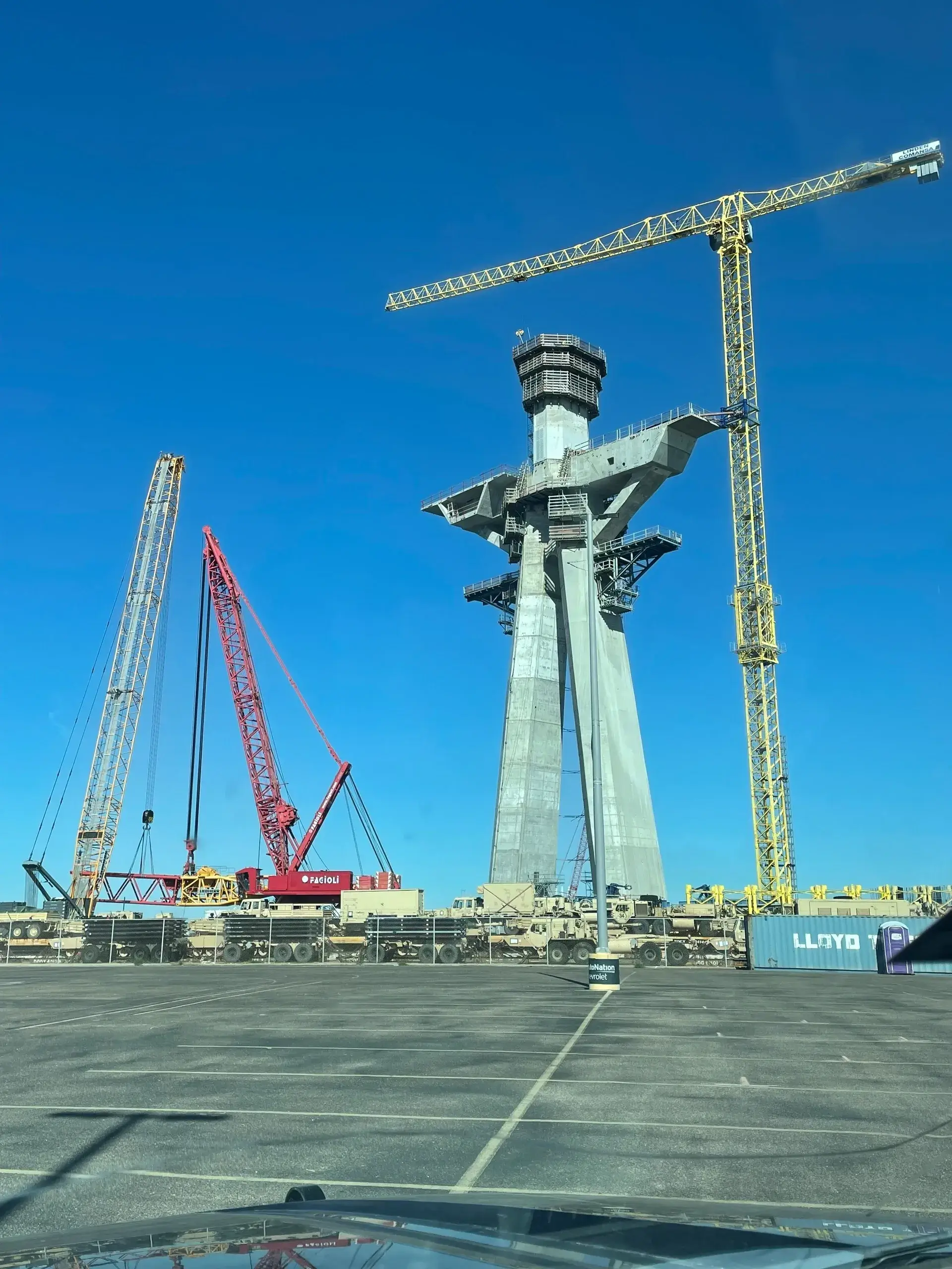 Tall structure under construction with cranes.