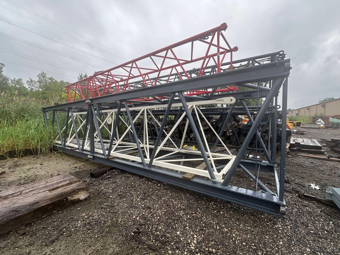 Stacked metal truss structures in an outdoor storage area.