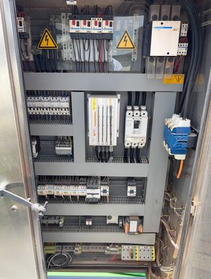Electrical control panel with circuit breakers and wiring.